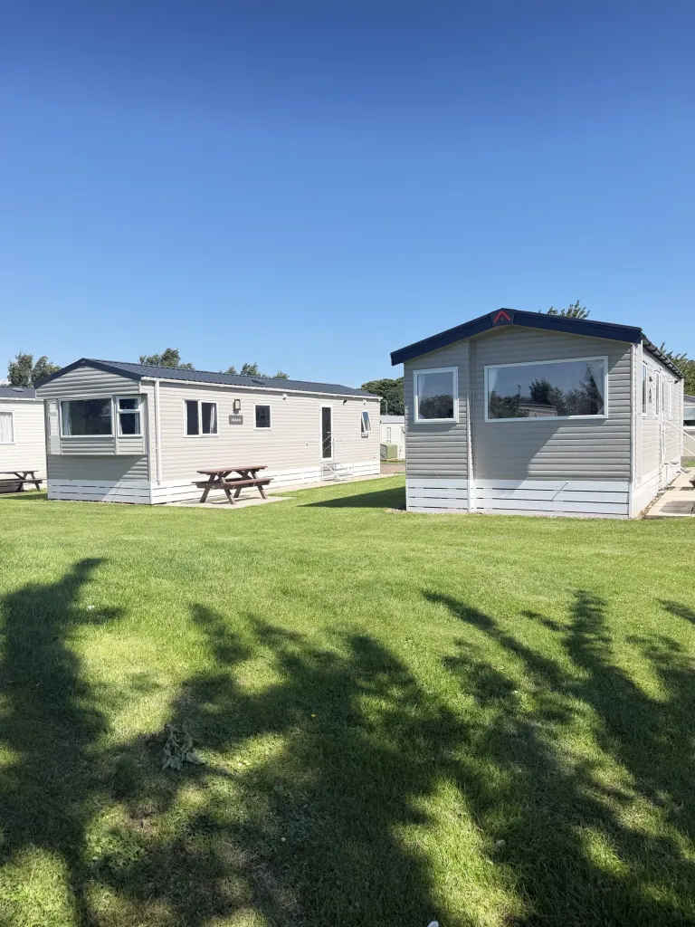 Holiday caravans with picnic benches at Gilsland Park, North Berwick