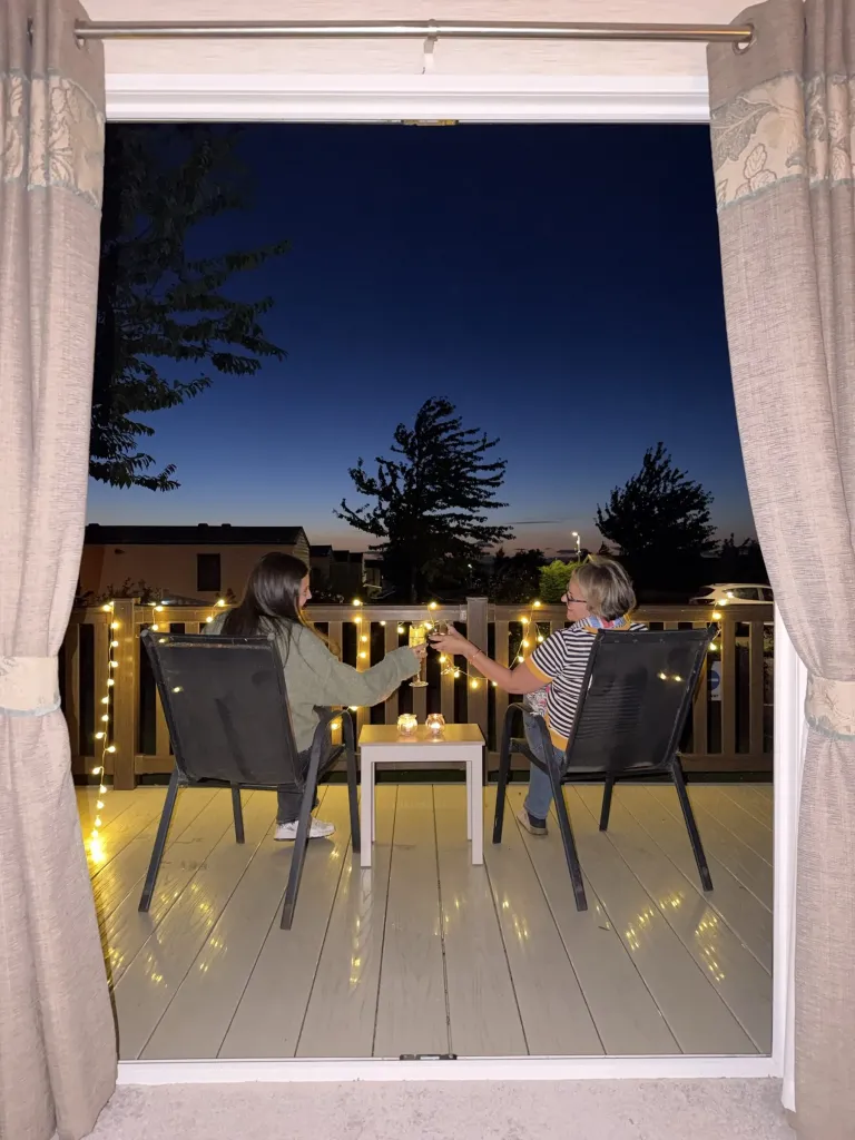 Drinks on a caravan deck at night at Gilsland Park, North Berwick