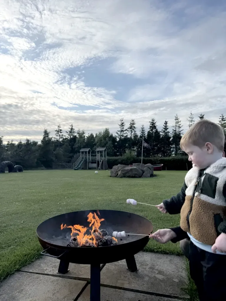 Toasting marshmallows over a fire pit at Gilsland Park