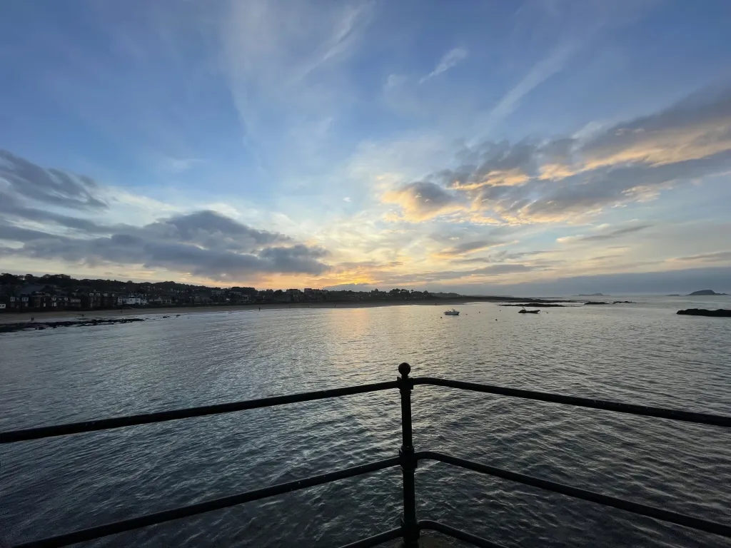 Sunset over the beach and harbour wall at North Berwick